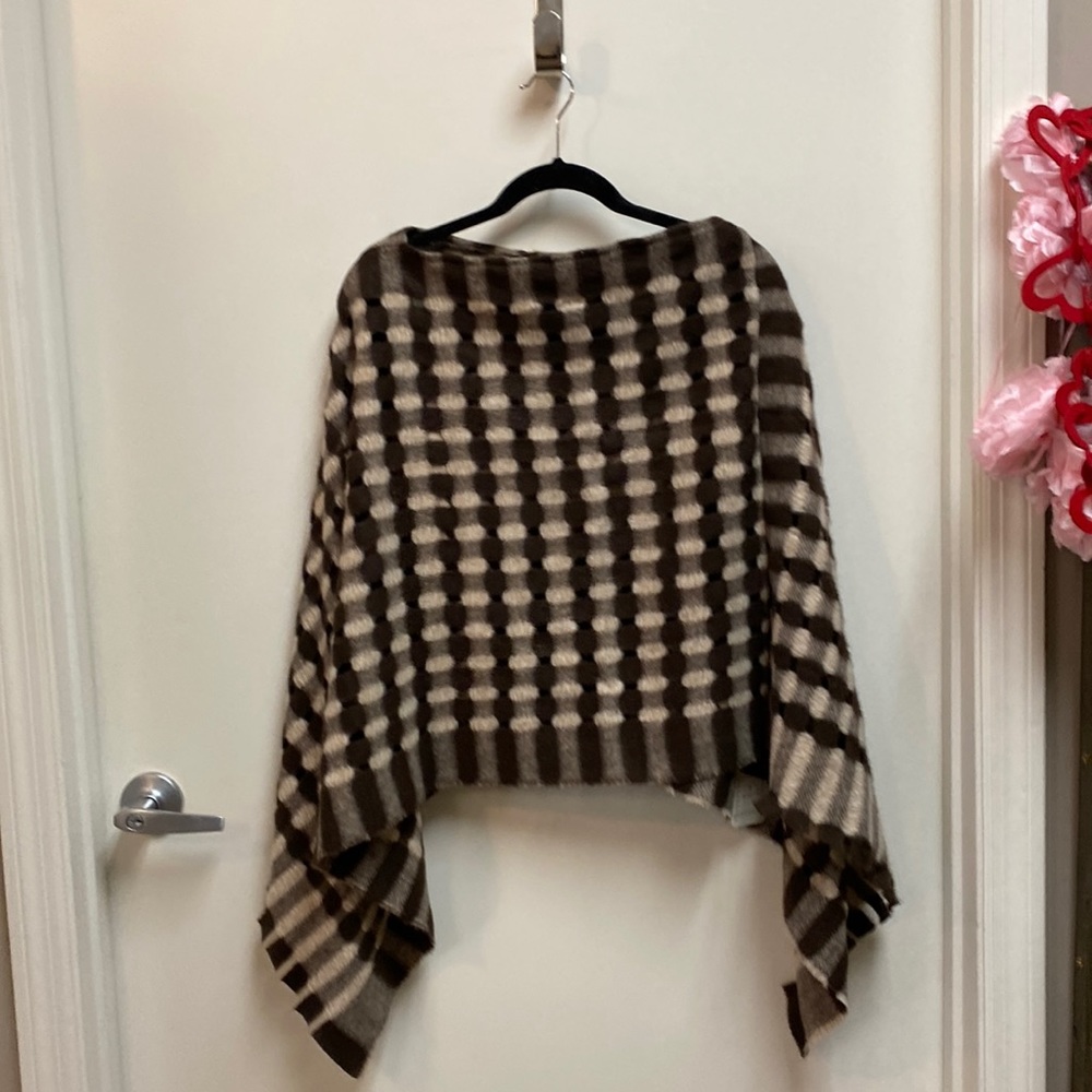 Short cape brown and tan plaid with fringed edge.